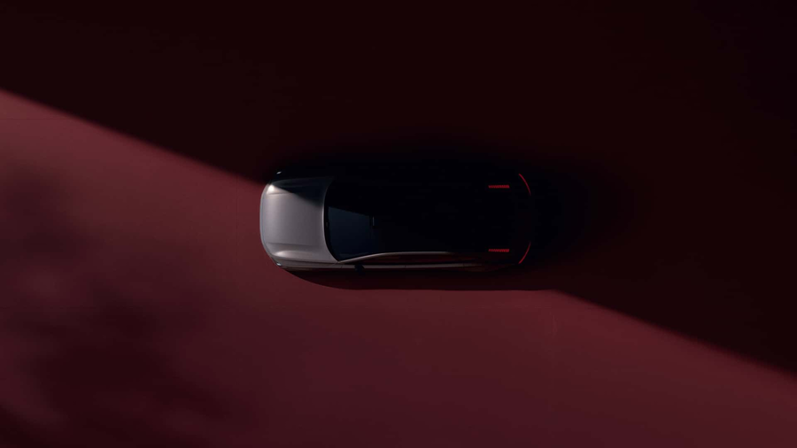 Volvo ES90 teaser widok z gory sylwetka na ciemnoczerwonym tle